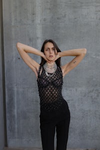 a woman posing with her hands on her head