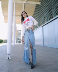 a woman in a denim skirt posing for a photo