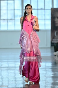 a model walks the runway at the show during london fashion week