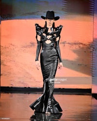 a model walks the runway wearing a leather dress and a hat during mercedes-benz fashion week spring/summer 2019