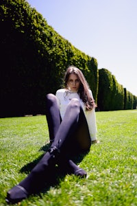 a woman sitting on the grass