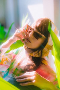 a woman is laying on a leaf